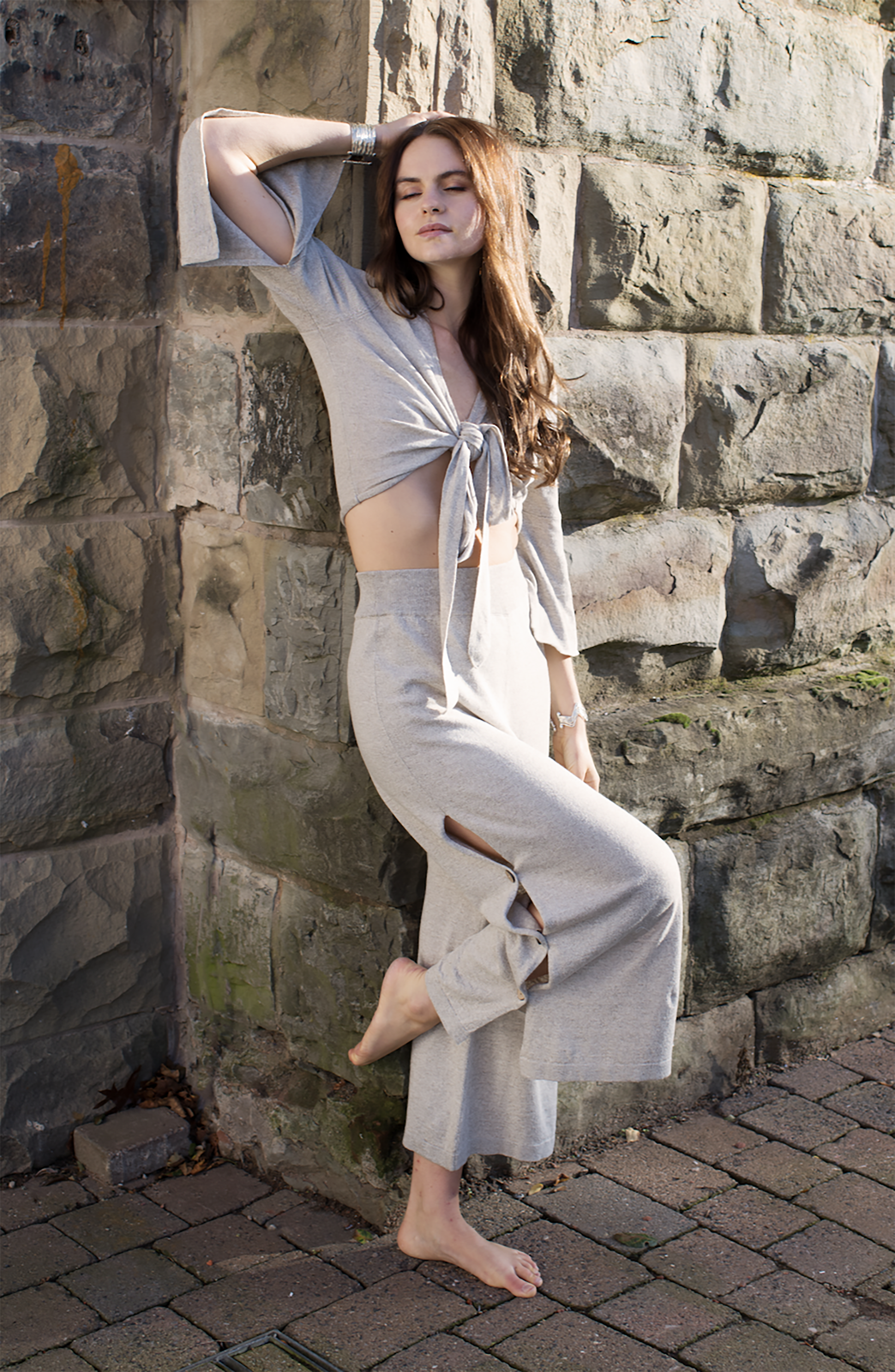 Model wearing oyster linen wrap top with adjustable tie and relaxed fit