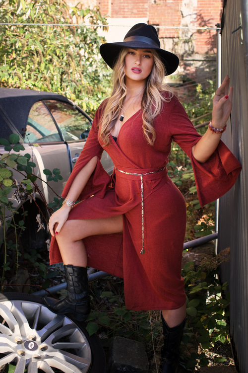 Rust red organic linen wrap dress with flowing silhouette and flared sleeves