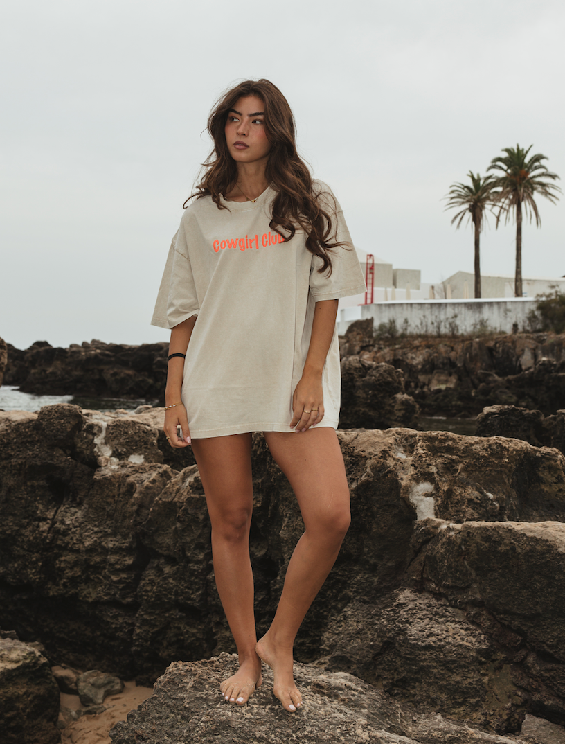 Cowgirl Club T-shirt in off-white organic cotton with orange embroidered logo and oversized fit