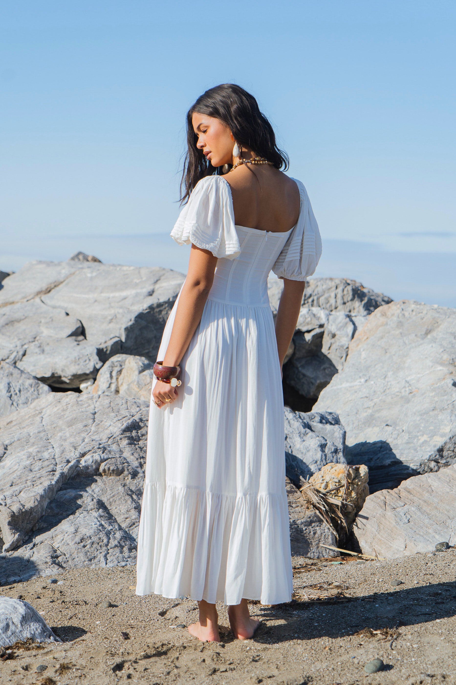 Side view of vintage white organic cotton dress with mermaid hem and flowing shape