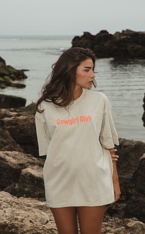 Cowgirl Club T-shirt in off-white organic cotton with orange embroidered logo and oversized fit