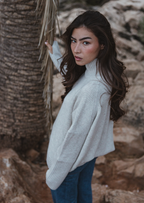 Valentina Jumper in oatmeal, handmade sustainable knit with high neck and thumb holes